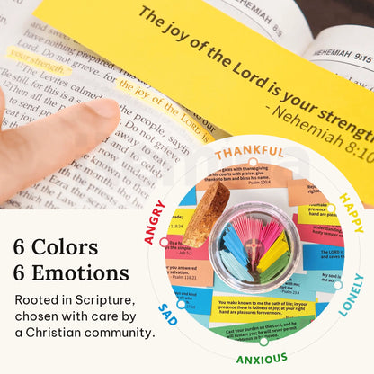 Bible verse from Nehemiah 8:10 highlighted with a yellow card reading “The joy of the Lord is your strength,” next to a graphic showing the six color-coded emotions represented in the Handmade Bible Verses Jar